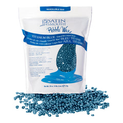 Bag of satin smooth pebble wax with blue wax beads on a white background