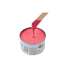 Can of pink wax with a spatula on a white background