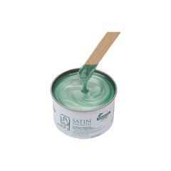 Green paint can with a wooden stirrer on a white background