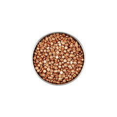 Metallic gold beads in a round container on a white background