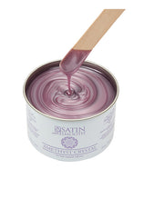 Dripping wax stick dipped into open can of Satin Smooth Amethyst Crystal Wax showing its color & texture