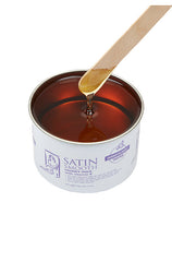 A canister of wax honey for epilation with a popsicle displaying its texture 
