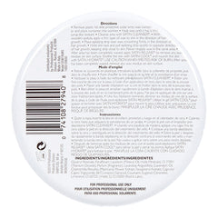 Back label of a hair product container with text and a barcode on a white background