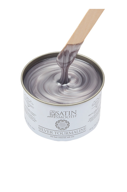 Dripping wax stick dipped into open can of Satin Smooth Silver Tourmaline Wax showing its color & texture