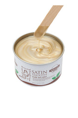 Dripping wax stick dipped into open can of Satin Smooth Pure Soy Wax showing its full creamy golden color & texture