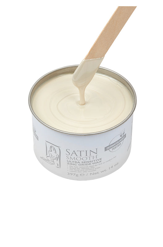 Dripping wax stick dipped into an open can of Satin Smooth Zinc Oxide Wax showing its full creamy beige color & texture